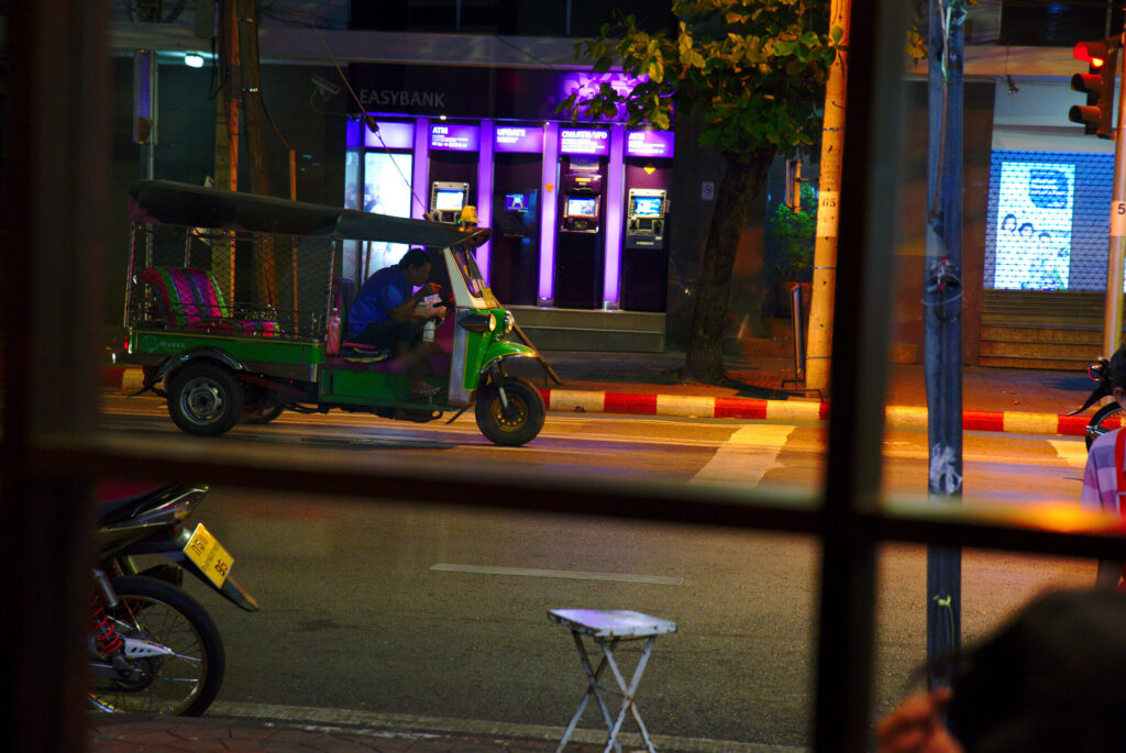 Tuk-tuk through a cafe window, first night, Bangkok