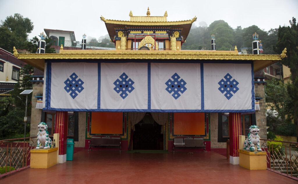 Temple porch hung with endless-knot curtains, Dharamshala and McLeod Ganj