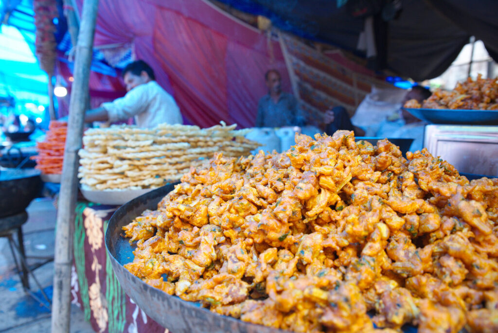 Fried snacks piled at a street stall, Dharamshala and McLeod Ganj
