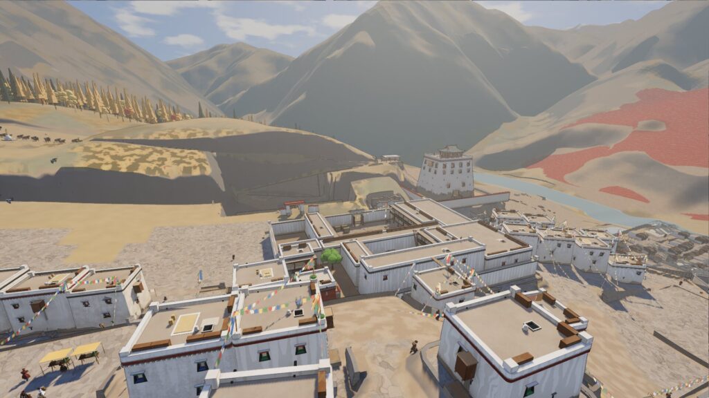 The rooftops of Dungkardo, a Tibetan border town built in Godot, under prayer flags with mountains behind