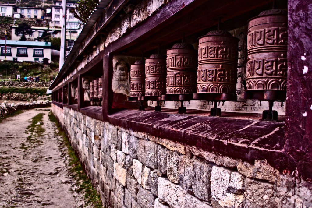 Prayer wheels along a stone wall, Everest Base Camp