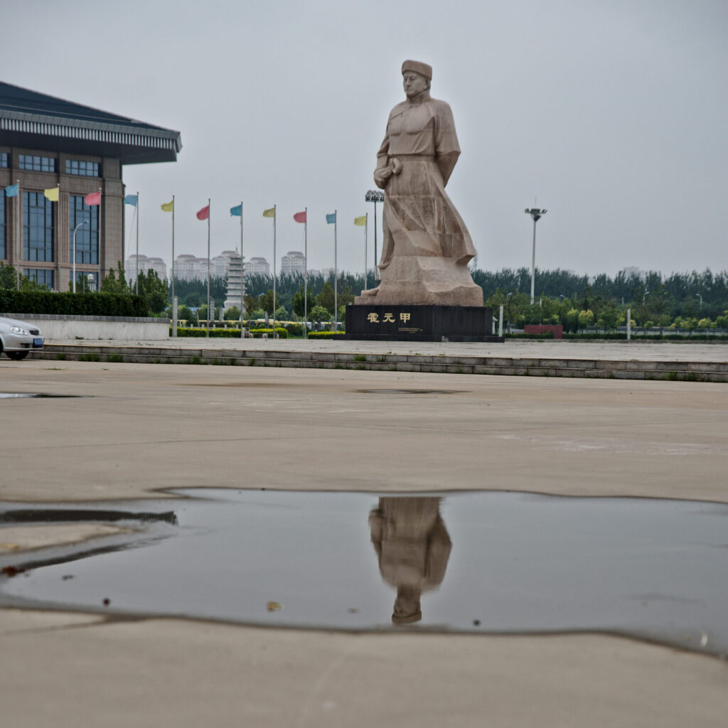 The statue reflected in a rain puddle, Huo Yuanjia Memorial Park