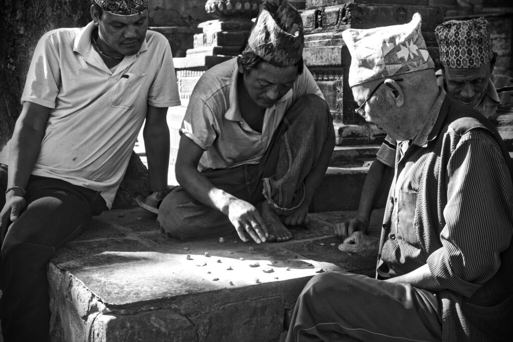 Men at a board game, black and white, Kathmandu, Autumn 2015