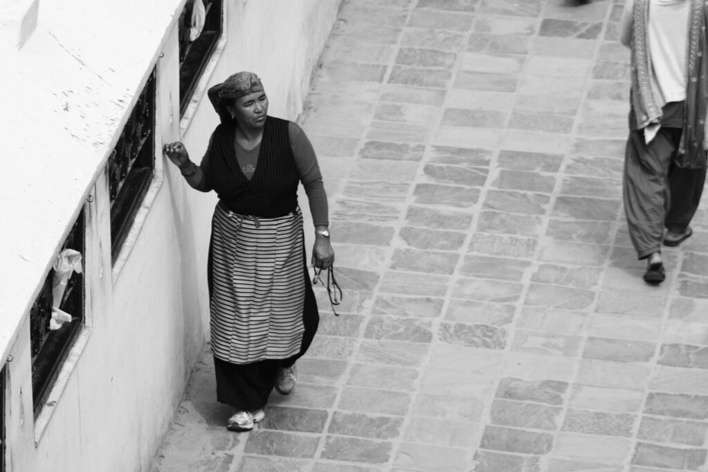 Woman at the prayer wheels, black and white, Kathmandu, Autumn 2015