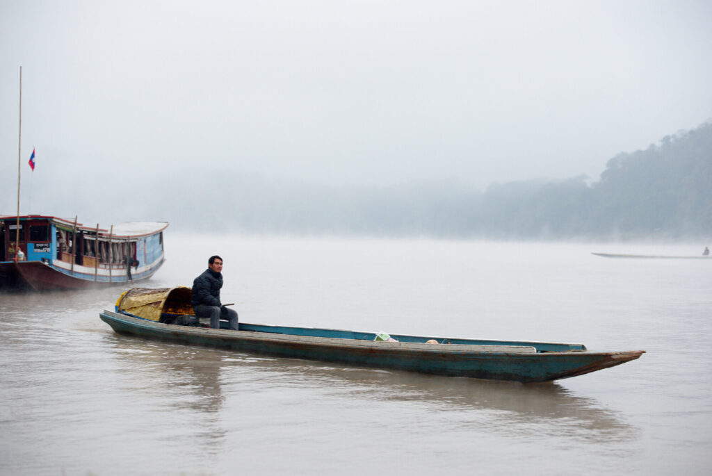 Boatman in the morning mist, Laos: Luang Prabang to Vientiane