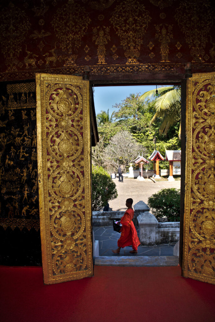 Temple doorway framing a monk, Laos: Luang Prabang to Vientiane