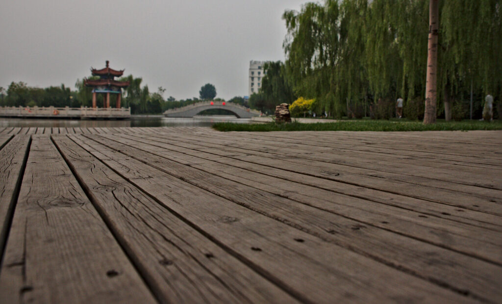 Boardwalk towards a pavilion and an arched bridge, Lutai at Mid-Autumn