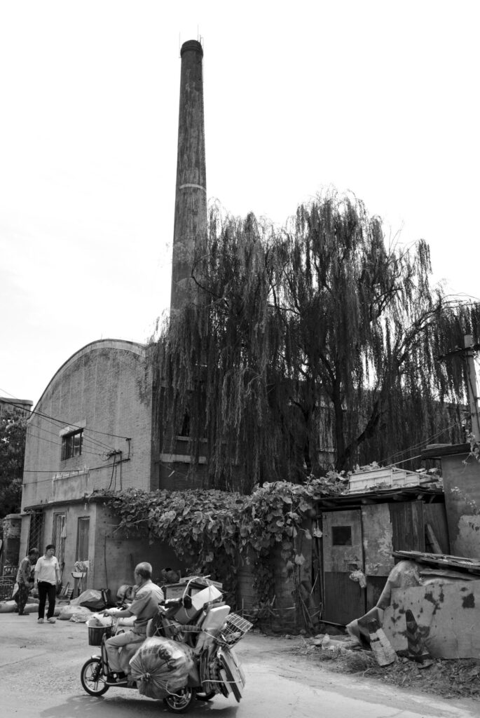The same corner in black and white, with a loaded tricycle, The Old Chimney