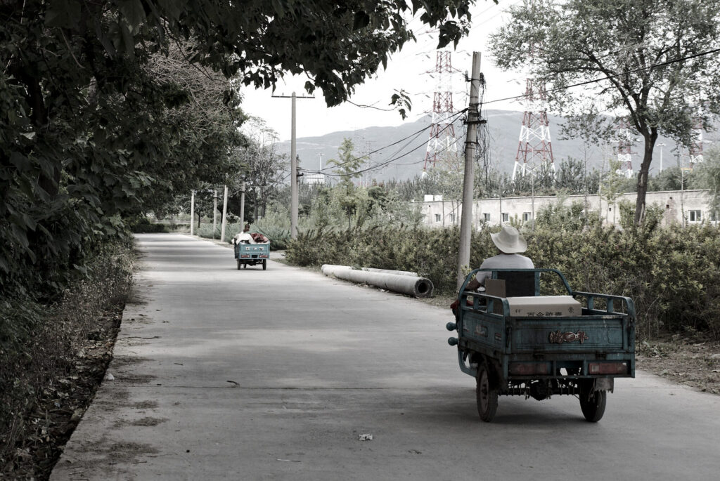 Tricycle cart on a lane, pylons and hills behind, The Old Chimney