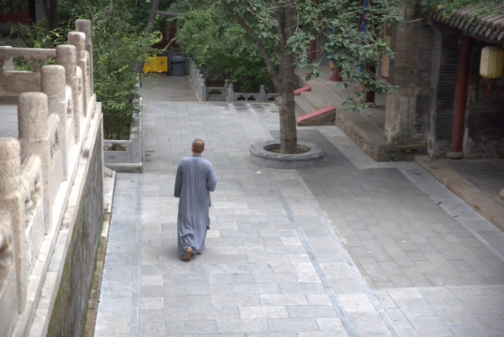 Monk crossing the courtyard, Tanzhe Temple