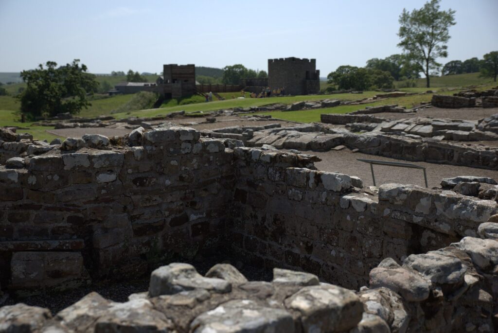 Excavated walls with the towers behind, Vindolanda