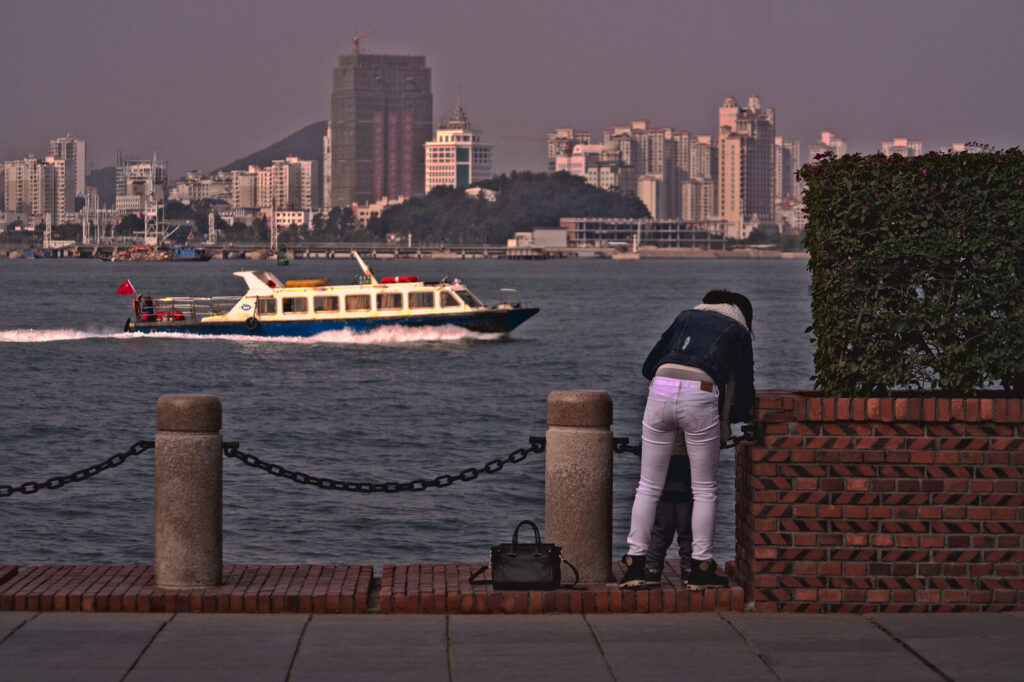 Ferry passing the sea wall, Xiamen in January
